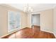 Bright dining room featuring hardwood floors, neutral paint, and a window that provides natural light at 105 Spring Forest Way, Sharpsburg, GA 30277