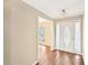 Bright foyer with hardwood floors, white trim, and a view into an adjacent room with natural light at 105 Spring Forest Way, Sharpsburg, GA 30277