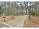 Charming brick home with a concrete driveway framed by trees and foliage at 105 Spring Forest Way, Sharpsburg, GA 30277
