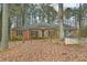 Charming brick home with a symmetrical design and mature trees in a wooded residential neighborhood at 105 Spring Forest Way, Sharpsburg, GA 30277