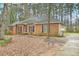 Traditional brick ranch home with a well-maintained lawn and a long driveway leading to a side-entry garage at 105 Spring Forest Way, Sharpsburg, GA 30277