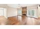 Spacious living room with hardwood floors, a stone fireplace, and French doors leading to the outdoors at 105 Spring Forest Way, Sharpsburg, GA 30277