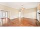 Large living room with hardwood floors, neutral paint, and fireplace with doorway to the entryway at 105 Spring Forest Way, Sharpsburg, GA 30277