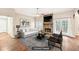 Staged living room featuring hardwood floors, a stone fireplace, neutral walls, and a view of the backyard at 105 Spring Forest Way, Sharpsburg, GA 30277