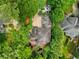 Aerial view showcases backyard pond, deck, and parking area of a home surrounded by green trees at 4000 Wieuca Ne Rd, Atlanta, GA 30342