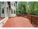 Spacious back deck with wood railing offering a scenic view of the surrounding lush greenery at 4000 Wieuca Ne Rd, Atlanta, GA 30342