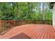 Large wooden deck overlooking lush backyard with mature trees offering exceptional outdoor living at 4000 Wieuca Ne Rd, Atlanta, GA 30342