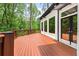 Exterior of home with a large wooden deck and french doors offering scenic nature views at 4000 Wieuca Ne Rd, Atlanta, GA 30342