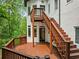 Multi-level wooden deck and staircase overlooking backyard with a wooded perimeter at 4000 Wieuca Ne Rd, Atlanta, GA 30342