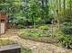 An attractive backyard pond, with stone edging, surrounded by green vegetation and a stone pathway at 4000 Wieuca Ne Rd, Atlanta, GA 30342