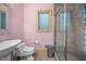 Compact bathroom featuring a glass-enclosed shower and a unique vessel sink with pink walls at 4000 Wieuca Ne Rd, Atlanta, GA 30342