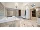 Spacious bathroom with a soaking tub, glass-enclosed shower, and dual vanities offering ample space and natural light at 4000 Wieuca Ne Rd, Atlanta, GA 30342