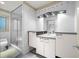 Bright bathroom featuring a glass enclosed shower, granite counters, and white cabinets at 4000 Wieuca Ne Rd, Atlanta, GA 30342