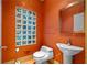 Quaint bathroom with colorful glass block window and stylish pedestal sink at 4000 Wieuca Ne Rd, Atlanta, GA 30342