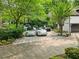 A concrete driveway, lined by shrubs, with several vehicles parked near the house at 4000 Wieuca Ne Rd, Atlanta, GA 30342