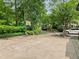 Expansive driveway featuring a basketball hoop and ample parking, surrounded by verdant greenery at 4000 Wieuca Ne Rd, Atlanta, GA 30342