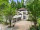 Exterior view of the house showing the three-car garage and well-maintained landscaping at 4000 Wieuca Ne Rd, Atlanta, GA 30342