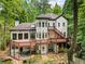 Rear exterior view showcasing a multi-level deck and patio, complementing the house's unique architecture at 4000 Wieuca Ne Rd, Atlanta, GA 30342