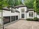 Beautiful home with a three-car garage and a modern, clean white exterior at 4000 Wieuca Ne Rd, Atlanta, GA 30342
