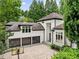 Stunning home exterior with a three-car garage, basketball hoop and beautiful landscaping at 4000 Wieuca Ne Rd, Atlanta, GA 30342
