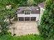 An aerial view of a three-car garage showing the black garage doors, a basketball hoop, and well-manicured shrubbery at 4000 Wieuca Ne Rd, Atlanta, GA 30342