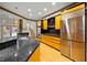 Modern kitchen with black countertops, stainless steel appliances, and wood flooring at 4000 Wieuca Ne Rd, Atlanta, GA 30342