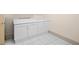 Functional laundry area with white cabinets, a countertop, and tile flooring for easy cleaning at 4000 Wieuca Ne Rd, Atlanta, GA 30342