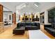 Spacious living room with wooden structural pillars, hardwood floors, and open layout to the kitchen at 4000 Wieuca Ne Rd, Atlanta, GA 30342