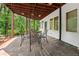 Covered patio with an outdoor dining area and seating featuring lush surrounding nature views at 4000 Wieuca Ne Rd, Atlanta, GA 30342