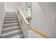 Modern staircase design with carpeted steps and stylish white railings at 4000 Wieuca Ne Rd, Atlanta, GA 30342