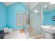 Vibrant blue bathroom with walk-in shower, toilet, sleek sink, and tile floors at 4000 Wieuca Rd Ne, Atlanta, GA 30342