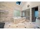 Stunning bathroom with marble tile, skylight, sunken tub, glass block window, and walk-in shower at 4000 Wieuca Rd Ne, Atlanta, GA 30342