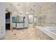 Large bathroom with mirrored walls, skylights, soaking tub and vanity with sink at 4000 Wieuca Rd Ne, Atlanta, GA 30342