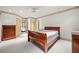 Well-lit bedroom with hardwood furniture, neutral tones and ensuite bathroom at 4000 Wieuca Rd Ne, Atlanta, GA 30342