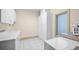 Clean laundry room with white cabinets, sink, tile floor and large window at 4000 Wieuca Rd Ne, Atlanta, GA 30342