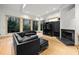 A comfortable living room with a fireplace, built-in entertainment center, and oversized windows at 4000 Wieuca Rd Ne, Atlanta, GA 30342