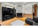 A living room features a fireplace, hardwood floors, natural light, and a large built-in media center at 4000 Wieuca Rd Ne, Atlanta, GA 30342