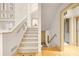 Inviting staircase with carpeted steps and a view of the open floor plan at 4000 Wieuca Rd Ne, Atlanta, GA 30342
