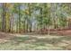 View of the backyard with mature trees and natural landscape, providing shade and privacy at 7030 Cascade Palmetto Hwy, Palmetto, GA 30268
