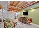 Open basement featuring a bar area, concrete floors, an olive painted accent wall, and exposed beam ceiling at 7030 Cascade Palmetto Hwy, Palmetto, GA 30268