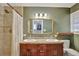 Bathroom featuring double sinks, a large mirror, and a tiled shower at 7030 Cascade Palmetto Hwy, Palmetto, GA 30268