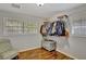 Bedroom with a chair, wood floors, window, and clothing rack at 7030 Cascade Palmetto Hwy, Palmetto, GA 30268