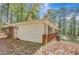 Exterior view of home with red brick and vinyl siding, surrounded by leafy ground at 7030 Cascade Palmetto Hwy, Palmetto, GA 30268