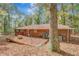 Home's brick exterior with deck and wooded area, surrounded by leafy ground at 7030 Cascade Palmetto Hwy, Palmetto, GA 30268