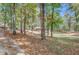 Residential home with a spacious front yard framed by mature trees creating a serene and private setting at 7030 Cascade Palmetto Hwy, Palmetto, GA 30268