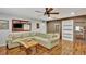 Spacious living room featuring hardwood floors, brick accents and a large sectional sofa perfect for relaxation at 7030 Cascade Palmetto Hwy, Palmetto, GA 30268