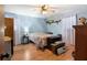 Bedroom with wood floor, blue walls, a ceiling fan, and ample natural light at 28 East Boxwood Dr, Cartersville, GA 30121