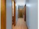 Hallway with painted walls, wood trim, and multiple doors leading to other rooms at 28 East Boxwood Dr, Cartersville, GA 30121