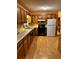Traditional kitchen with wooden cabinets, laminate countertop, and black appliances at 28 East Boxwood Dr, Cartersville, GA 30121