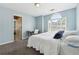 Bedroom features cozy carpet, blue walls, and an arched window at 3004 Westray Nw Ct, Marietta, GA 30064